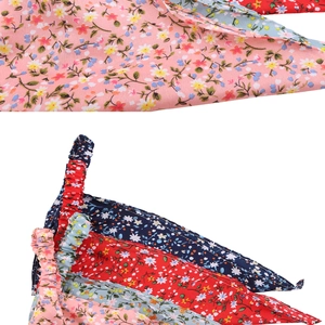 Detail showing floral print triangle bandanas in pink, blue, and red fabric textures