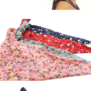 Stack of colorful floral cotton bandanas in pink, red, light blue and navy blue