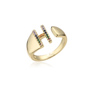 Macro detail of 18K gold letter H ring featuring micro-inset rainbow gemstones