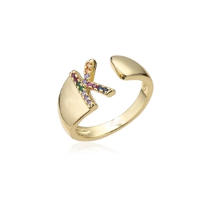 Macro detail of 18K gold letter K ring with vibrant multicolor cubic zirconia inlays