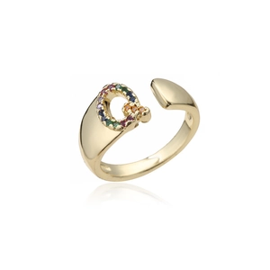 Detailed close-up of 18K gold ring featuring a letter Q set with colorful gemstones