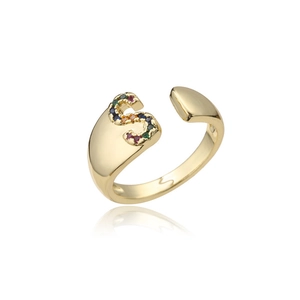 Detailed view of 18K gold letter S ring with micro-set colorful gemstones on white background