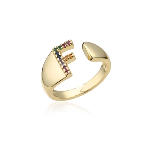 Macro detail of 18K gold letter F ring featuring vibrant colorful zircon stone inlays