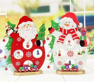 Detail of wooden Christmas ornaments featuring Santa, snowman, and painted mini train figurines