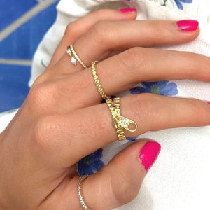 Set of gold zipper rings with crystal inlays worn on a hand for a vintage luxury look