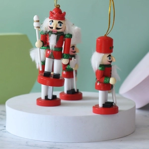Three 10cm wooden nutcracker ornaments in red, green, and white for Christmas tree decor