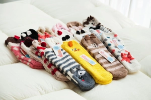 Detailed view of assorted soft coral fleece winter socks with cute animal patterns