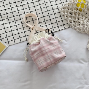 Detailed top view of pink checkered drawstring bucket bag with adjustable strap