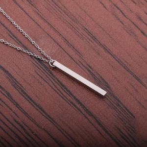 Close-up of a silver polished rectangular bar pendant on a stainless steel chain necklace