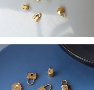 Detail view of assorted gold plated 18K steel heart and square shaped lock pendants