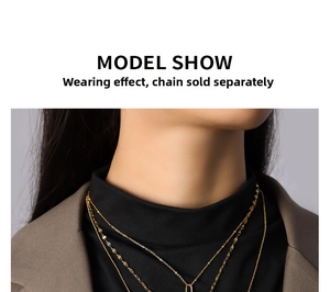 Close-up of layered gold titanium steel necklaces styled on a model with a blazer
