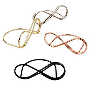Detail of infinity loop metal place card holders in gold, silver, rose gold and black