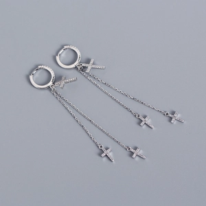 Detailed view of silver S925 sterling silver cross earrings with shimmering tassels