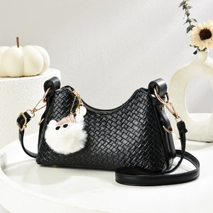 Borsa a tracolla intrecciata nera con dettagli dorati e portachiavi in peluche bianco
