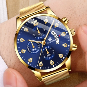 Gros plan d'une montre SHAARMS dorée avec cadran bleu et bracelet en maille