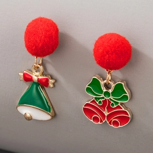 Detailed macro view of asymmetric Christmas earrings with green tree and red bell poms