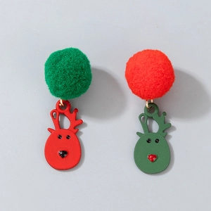 Close-up of Christmas stud earrings with plush pompoms and metal reindeer pendants