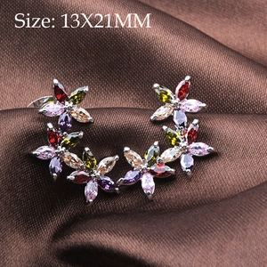 Macro view of floral copper earrings with marquise zirconia and 13x21mm size label