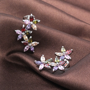 Macro shot of three-flower stud earrings with colorful AAA marquise zircon on silk