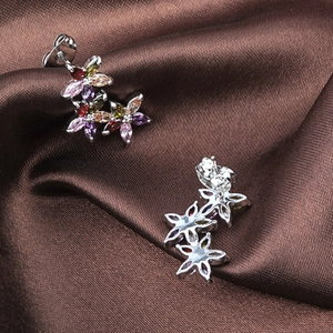 Detail of silver floral earrings with colorful AAA marquise zircon on brown silk background