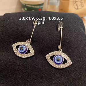 Detailed view of Evil Eye brooch with dimensions 3.0x1.9cm and rhinestone accents