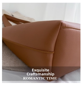 Detail of lychee pattern brown leather tote bag with fine stitching and macro texture
