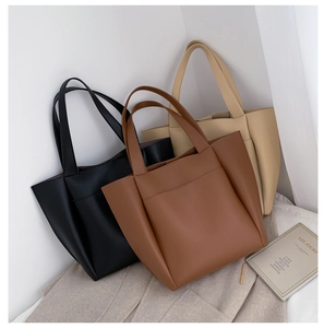 Three PU leather tote bags in black, brown, and beige displayed in a minimalist setting