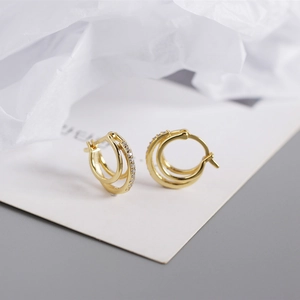 Detailed side view of gold-plated double hoop earrings featuring pavé micro zircons