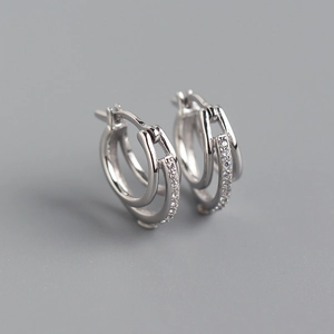 Detailed close-up of S925 sterling silver double hoop earrings with sparkling zircon stones