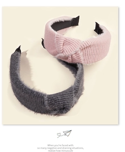 Detail view of pink and dark grey knitted mohair headbands with ribbed texture
