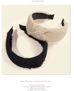 Detail of vintage beige and black corduroy headbands with plush edges and knot design