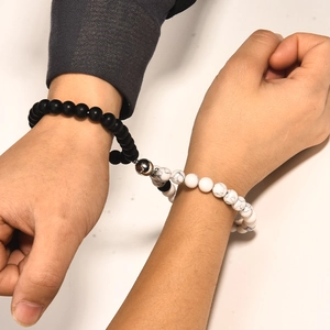 Detailed close-up of couples magnetic bracelets with 8mm black and white stone beads