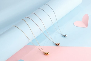 Detailed close-up of 18K gold-plated gourd pendants in gold, rose gold and silver finishes