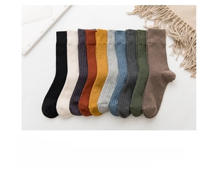 Detailed flat lay of ten vintage-colored cotton ribbed mid-calf socks in Japanese style