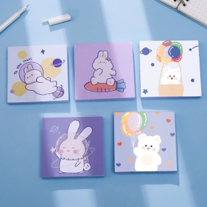 Detailed flat lay of cute space and animal themed sticky notes set on blue surface