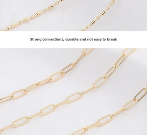 Detail of golden copper bead chain and paperclip chain with secure connections