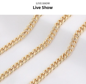 Macro shot of polished gold cuban link chains with embossed flat O-rings for DIY jewelry