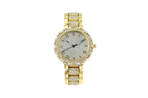 Gros plan d'une montre dorée pour femme avec cadran romain et sertie de strass