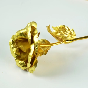 Artifical 24K gold foil rose with realistic petals and leaves on white background