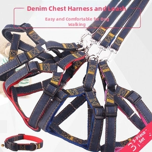 Close-up of denim pet harness set with yellow stitching and metal bell collar detail