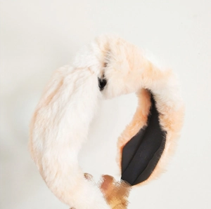 Detailed close-up of soft rabbit fur-style knotted headband in a beige gradient finish