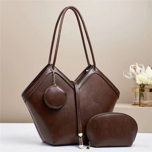 Three-piece brown retro tote bag set with shoulder bag, pouch and charm on minimalist background