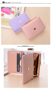 Detail of short tri-fold wallet showing interior card slots and heart metal hardware