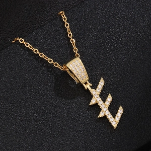 Close-up of gold lightning bolt E pendant necklace with micro-set cubic zirconia
