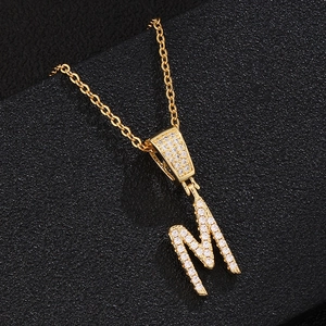 Elegant gold-tone letter M pendant necklace with shimmering cubic zirconia stones