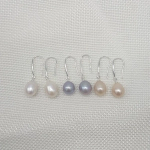 Three pairs of natural freshwater pearl drop earrings in white, blue, and pink colors