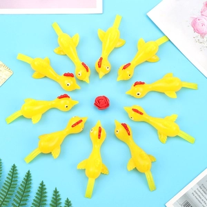 Detailed view of ten yellow plastic toy chickens arranged in a circle on blue background