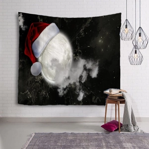 Detail of Christmas wall tapestry featuring a glowing moon wearing a Santa hat on a brick wall