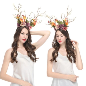 Detail view of handmade floral headpiece with simulation branches and colorful flowers