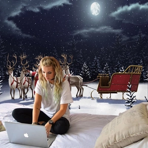 Cozy bedroom scene featuring a Christmas wall tapestry with Santa and reindeer scenery